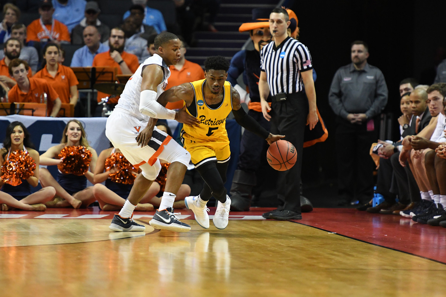 Jourdan Grant of the No. 16 seed UMBC Retrievers dribbles the ball past a player with the No. 1 seed Virginia Cavaliers March 16 in the first round of the 2018 NCAA Tournament in Charlotte, N.C. Grant is a graduate of Archbishop Spalding High School in Severn, Maryland. His team from the University of Maryland, Baltimore County defeated Virginia 74-54. It was the first time in men’s NCAA Tournament history that a No. 16 seed beat a No. 1 seed.
